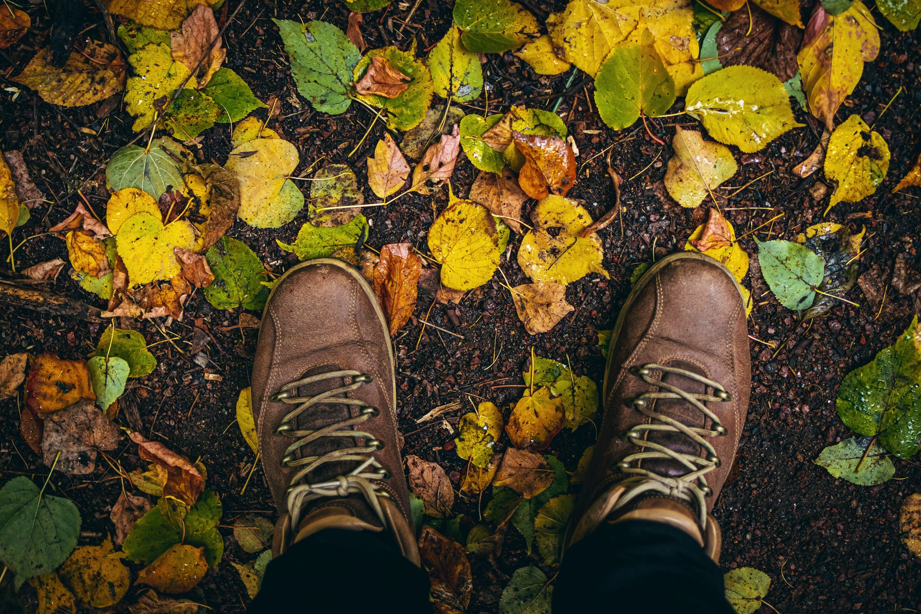 high angle photo of person wearing shoes
