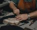 shoemaker cutting leather